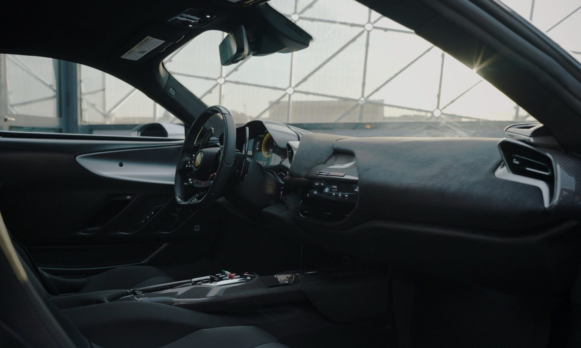Official Ferrari CZ26 interior with black technical fabric and carbon-fiber dash