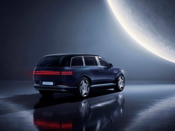 Rear three-quarter of a dark blue Genesis GV90 First Edition in a studio