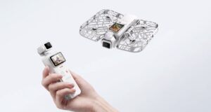 Hand holding HOVERAir VERSA pocket gimbal with flying cage-protected camera unit