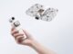 HOVERAir VERSA Is a Pocket Gimbal Camera That Flies Hand holding HOVERAir VERSA pocket gimbal with flying cage-protected camera unit