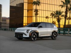 Kia EV3 Starts at $29,890 as Kia’s Cheapest US Electric SUV White 2027 Kia EV3 parked in front of a gold-glass office building at sunset