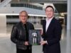 Jensen Huang and LG chairman Kwang Mo Koo hold a signed LG NVIDIA humanoid robot plaque