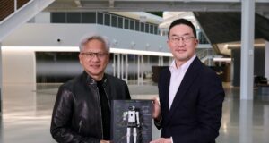 Jensen Huang and LG chairman Kwang Mo Koo hold a signed LG NVIDIA humanoid robot plaque