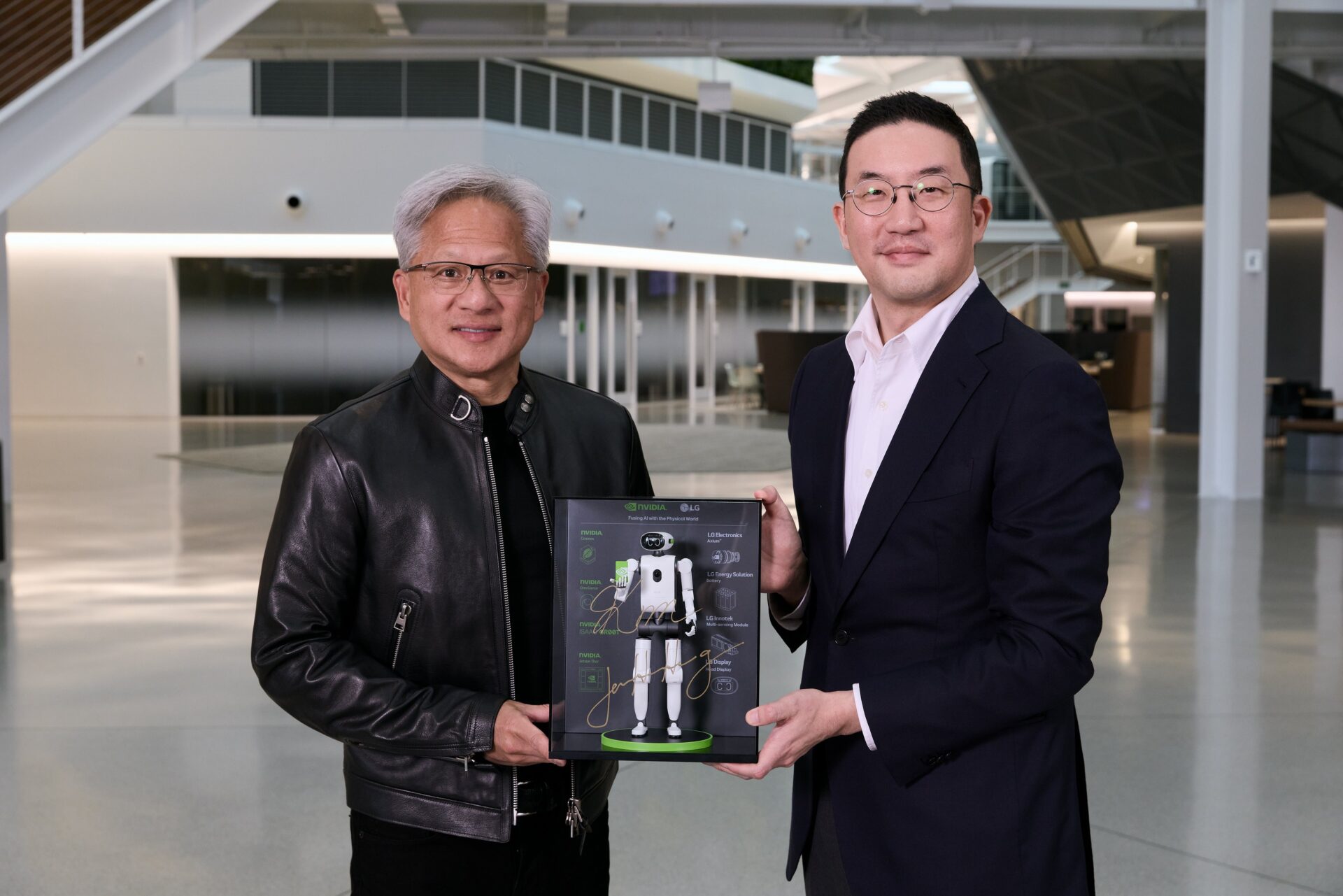 lg-nvidia-humanoid-robot-koo-huang Jensen Huang and LG chairman Kwang Mo Koo hold a signed LG NVIDIA humanoid robot plaque