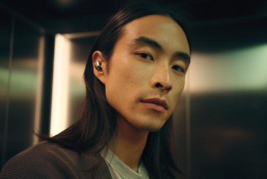 Person wearing Sennheiser Momentum True Wireless 5 earbuds in white