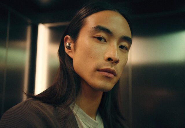 Person wearing Sennheiser Momentum True Wireless 5 earbuds in white
