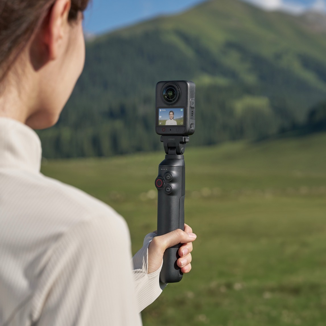 Official DJI Osmo 360 II on an Osmo grip, showing the front screen and magnetic mount