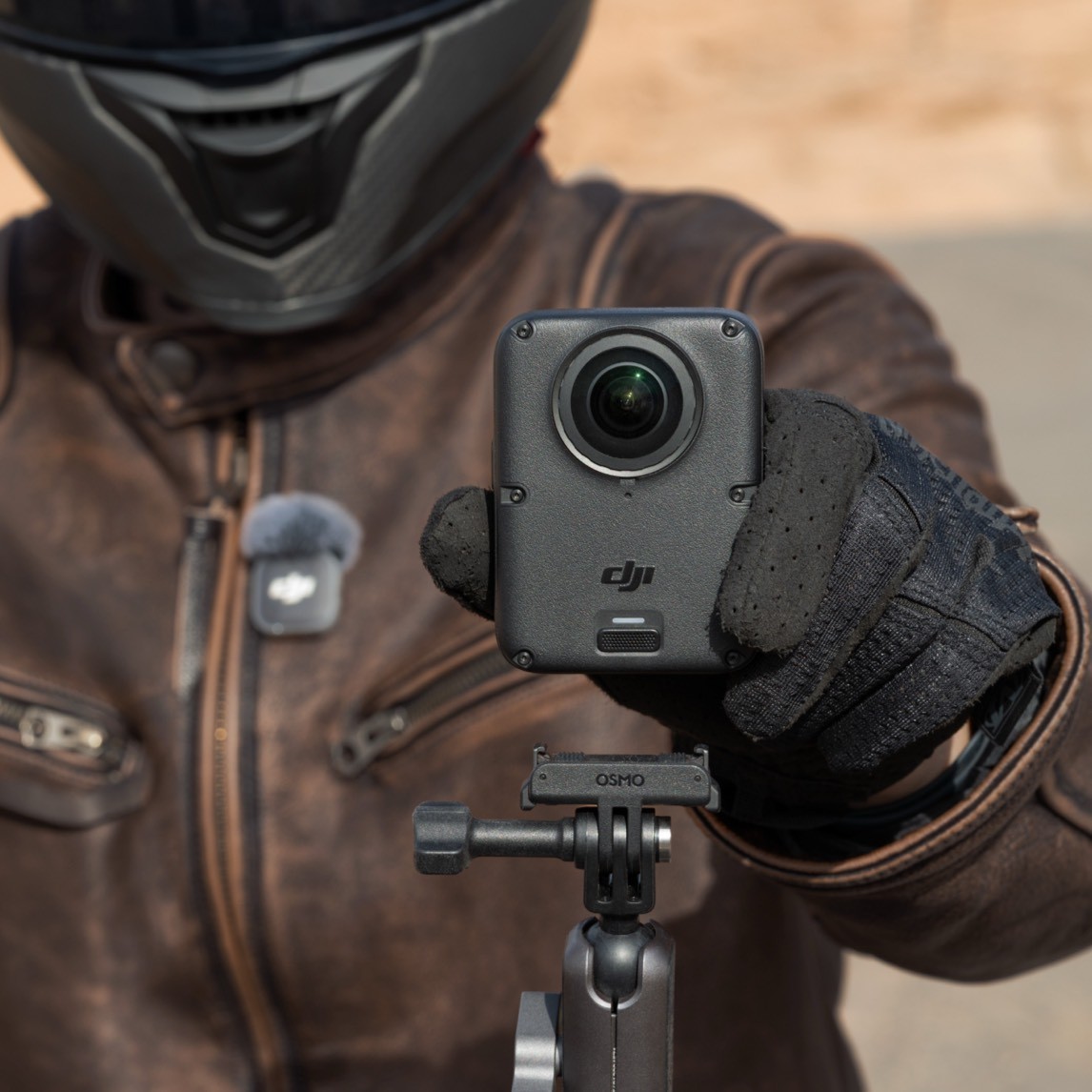 Official DJI Osmo 360 II held toward the camera, showing the exposed 360 lens