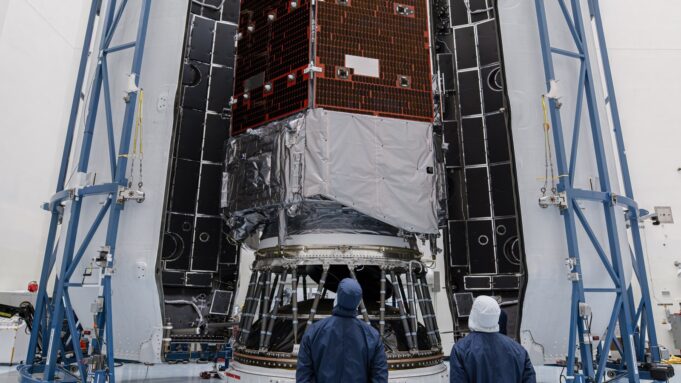 How to watch NASA’s Roman Space Telescope launch Technicians in blue clean-room suits stand before NASA's Nancy Grace Roman Space Telescope inside open Falcon Heavy fairing halves