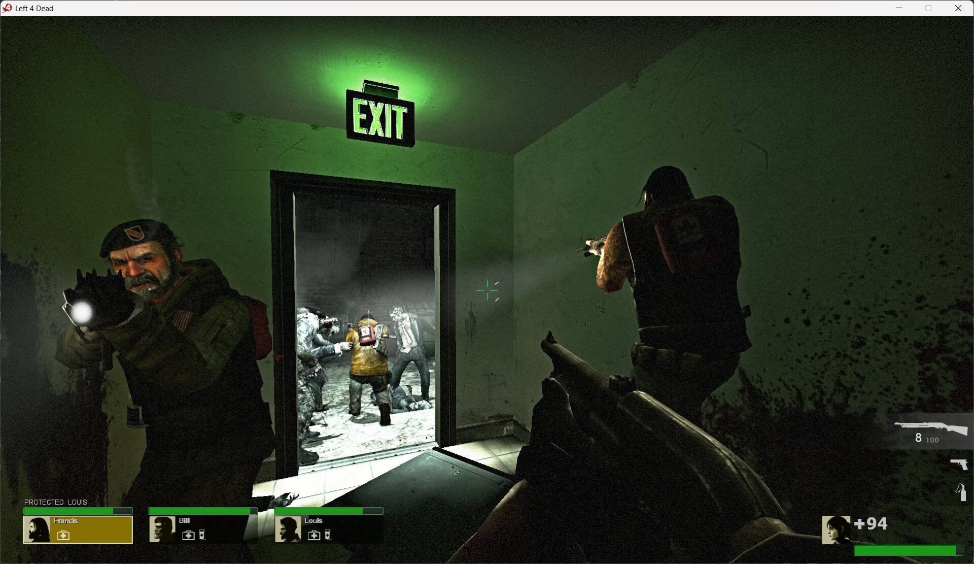 Early Left 4 Dead build with a green exit sign, survivors, and a work-in-progress HUD