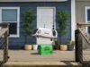 Zipline drone lowering an Uber Eats bag toward a front porch