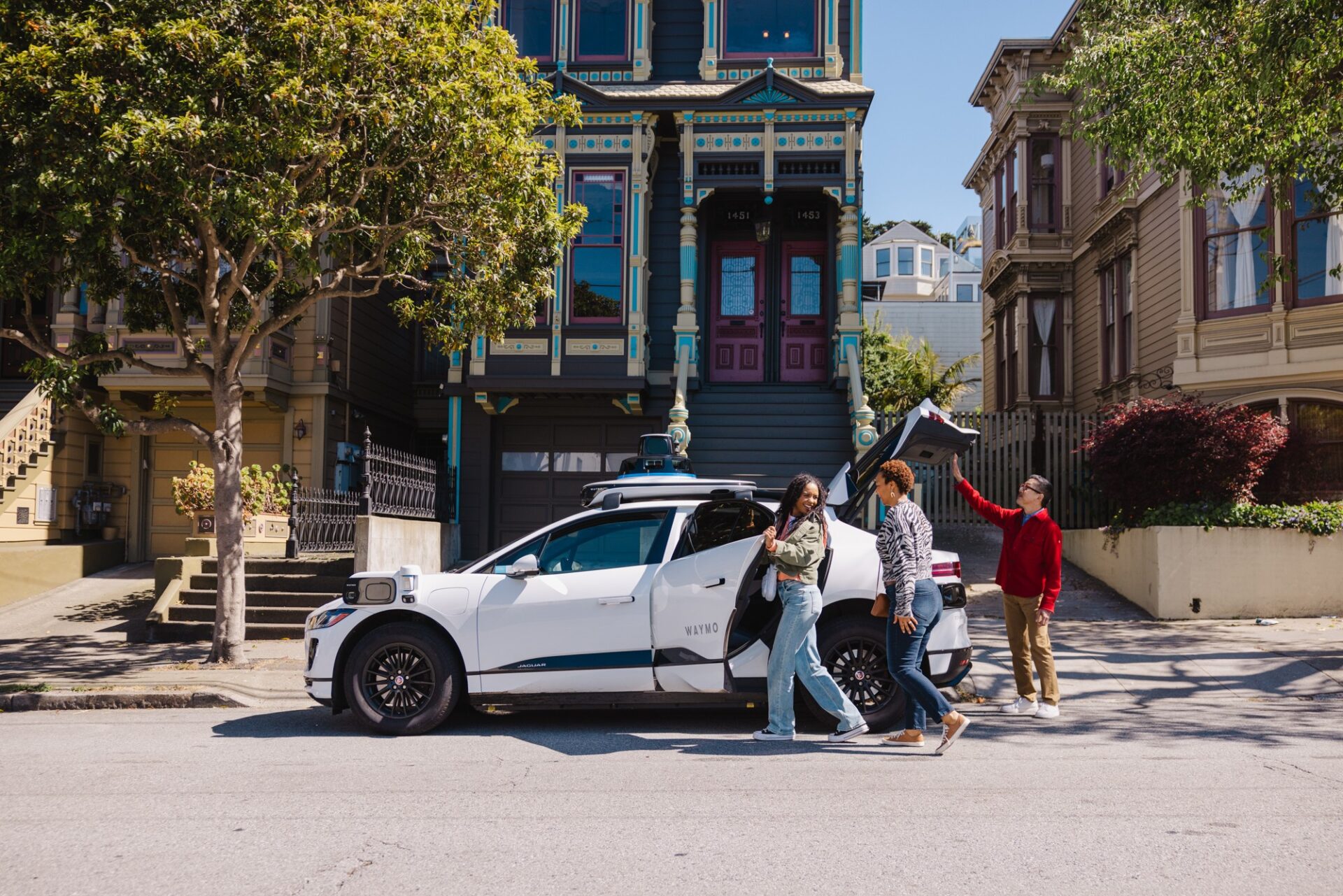 A Waymo Jaguar I-PACE robotaxi driving on a San Francisco street