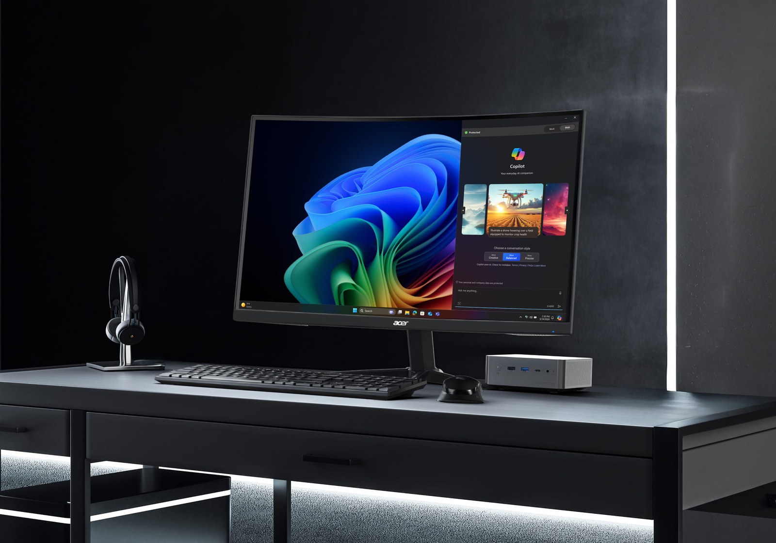 Acer Veriton RI110 AI Mini Workstation on a desk beside a monitor running Windows 11 Copilot