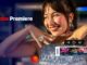 Smiling woman in a ruffled top with an Adobe Premiere timeline overlay and playback controls