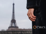 Circular Ring 2 worn on a hand with the Eiffel Tower in the background