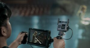 DJI SDR Transmission 2 receiver mounted beside a handheld production monitor