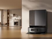 Roomba Max 875 Combo docked at its AutoWash Dock in a bright living room.