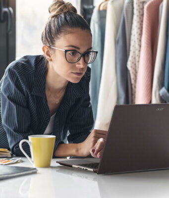 Acer Vero 16 Laptop Pairs Tool-Free Repairability With Core Ultra X9 and 3K OLED Acer Vero 16 laptop open on a white table while its owner works in a bright studio.