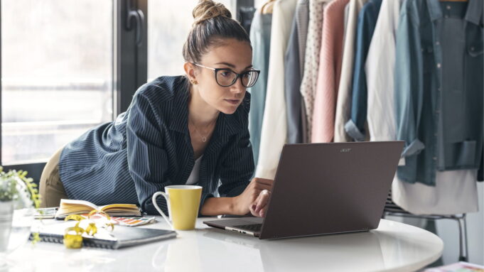Acer Vero 16 Laptop Pairs Tool-Free Repairability With Core Ultra X9 and 3K OLED Acer Vero 16 laptop open on a white table while its owner works in a bright studio.