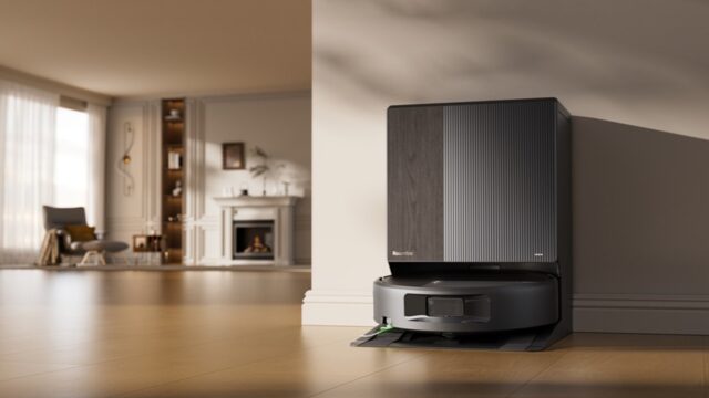 Roomba Max 875 Combo docked at its AutoWash Dock in a bright living room.