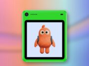 Freckle phone in green with an orange character on its screen against a coral and blue editorial background