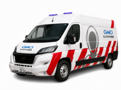 GMO Humanoid Ambulance Brings Repairs to Broken Robots GMO humanoid ambulance maintenance van with red stripes and purple roof lights