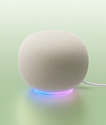 Google Home MCP Opens Early Access White Google Home Speaker on a mint backdrop with a blue-to-purple light ring and power cable