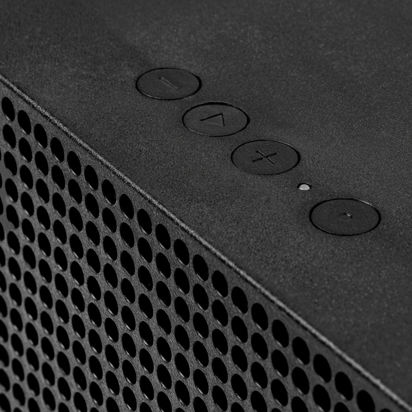 Close-up of four round buttons and a small status light on the top of a black IKEA Badkruka speaker