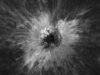 Overhead black-and-white Lunar Reconnaissance Orbiter view of McGetchin crater, a dark pit surrounded by a bright starburst of ejected debris