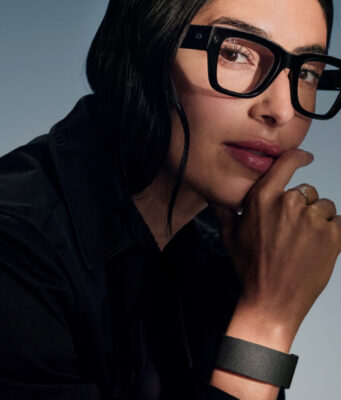 Meta hologram Hits Ray-Ban Display This Fall Woman wearing Meta Ray-Ban Display glasses and Neural Band