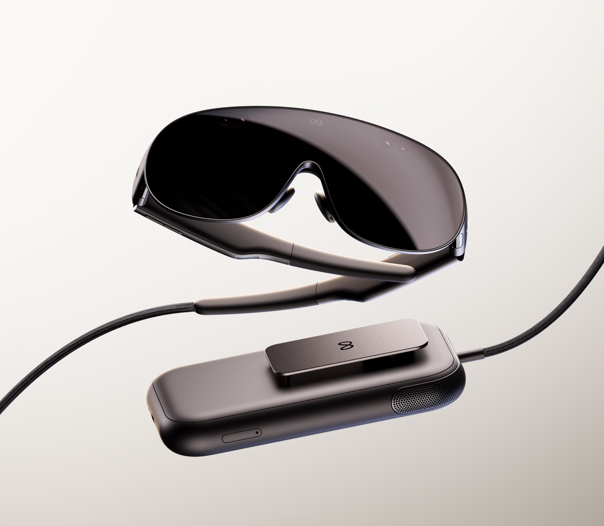 Meta VR Glasses connected by a tether to their pocket-sized compute puck