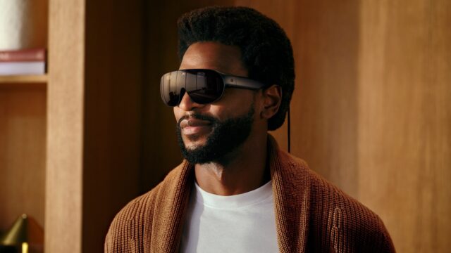 A man wearing Meta VR Glasses, which look like oversized black sunglasses