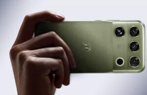 Motorola Signature 27 in PANTONE Capulet Olive held in hand, showing its quad camera housing with B&O branding