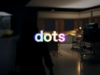 OpenAI dots launch-film poster showing illuminated dots lettering in a dim office