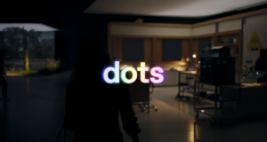 OpenAI dots launch-film poster showing illuminated dots lettering in a dim office