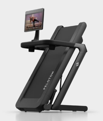 Peloton Tread Flex Starts at $2,195 Peloton Tread Flex folded upright on a pale studio floor with a swivel screen showing a strength class