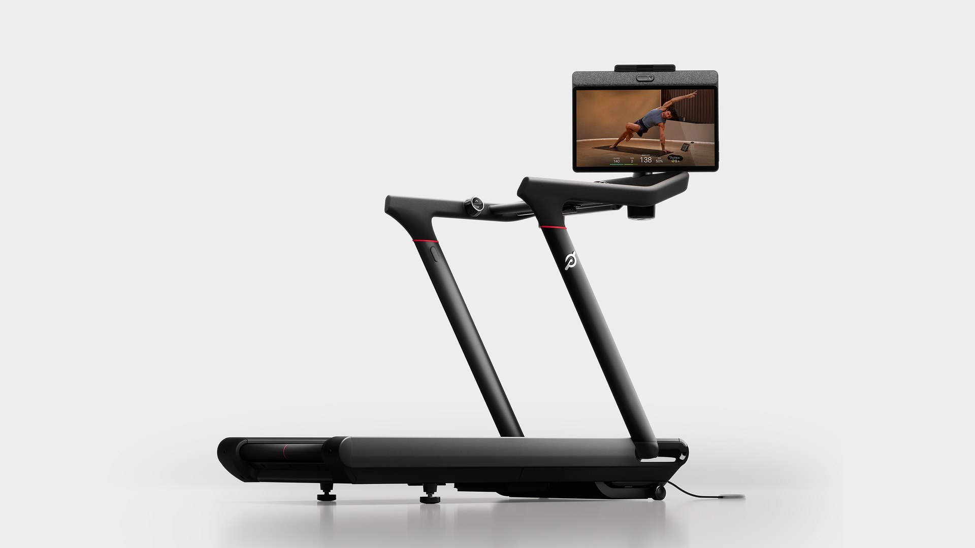 Peloton Tread Vision treadmill in profile with a swivel screen showing a floor strength class