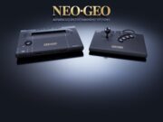 Neo Geo AES+ Console Remake Delayed to September 16, 2027 NEOGEO AES+ console and arcade stick in black under the gold Neo Geo logo