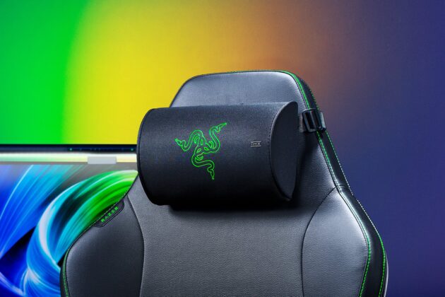 Razer Clio X head cushion on a gaming chair headrest in front of a colorful monitor