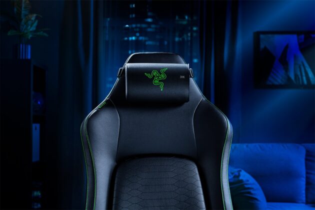 Razer gaming chair with the Clio X cushion in a blue-lit living room
