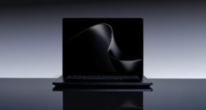 Microsoft Surface Laptop Ultra open on a dark studio table, keyboard and 15-inch display visible
