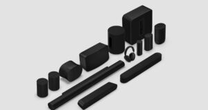 Black Sonos speakers, soundbars, sub, and headphones arranged on a light gray studio background