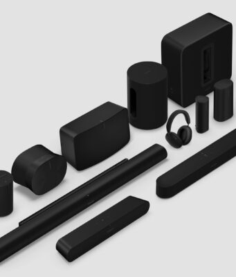 Sonos 27 adds AI control and a refreshed app Black Sonos speakers, soundbars, sub, and headphones arranged on a light gray studio background