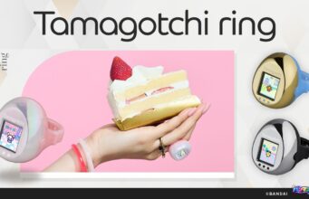 Tamagotchi ring: Bandai’s 28mm color LCD finger pet Three Tamagotchi ring colorways and a hand wearing the pearlescent pink model beside a cake slice