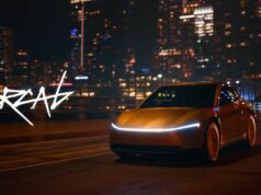 Tesla Cybercab robotaxi rides are live in Austin Gold Tesla Cybercab driving on a city highway at night with a light bar across the nose
