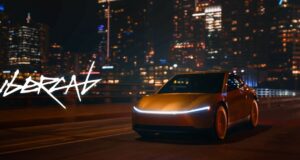 Tesla Cybercab robotaxi rides are live in Austin Gold Tesla Cybercab driving on a city highway at night with a light bar across the nose