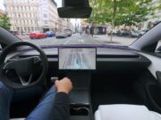Tesla cabin with a visualization map on the center screen while the car drives through a European city street