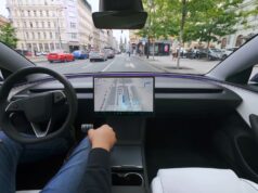 Tesla FSD Supervised Approved in Czechia Tesla cabin with a visualization map on the center screen while the car drives through a European city street