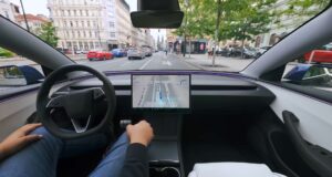 Tesla FSD Supervised Approved in Czechia Tesla cabin with a visualization map on the center screen while the car drives through a European city street