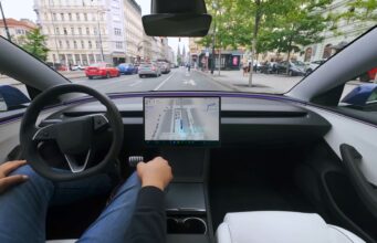 Tesla FSD Supervised Approved in Czechia Tesla cabin with a visualization map on the center screen while the car drives through a European city street